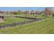 Large backyard with a well-maintained lawn, wood fence, and play structure for Gathering fun at 6472 Independence Ct, Pendleton, IN 46064