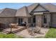 Spacious backyard featuring a wooden deck with dining set and a stone patio with fire pit and chair set at 6472 Independence Ct, Pendleton, IN 46064