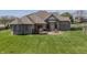 Spacious backyard with a deck, patio area and lush green lawn on a sunny day for outdoor living at 6472 Independence Ct, Pendleton, IN 46064