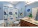 This colorful bathroom features a shower curtain with sea creatures and blue walls at 6472 Independence Ct, Pendleton, IN 46064
