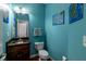 Stylish half-bathroom with granite countertop, turtle artwork, and vibrant turquoise walls at 6472 Independence Ct, Pendleton, IN 46064