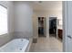 Bathroom featuring a large soaking tub and access to two walk-in closets at 6472 Independence Ct, Pendleton, IN 46064