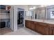 Bathroom with double sinks, walk in closets, vanity, and large mirror at 6472 Independence Ct, Pendleton, IN 46064