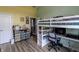 This vibrant bedroom features a loft bed with a built-in desk and drawers at 6472 Independence Ct, Pendleton, IN 46064