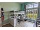 This colorful bedroom has a loft bed with a built-in desk and large windows at 6472 Independence Ct, Pendleton, IN 46064