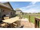 Backyard patio with outdoor seating set, grill, and deck on green lawn, great for summer fun at 6472 Independence Ct, Pendleton, IN 46064