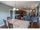 Dining room with table, chairs, wood floor and open view to kitchen with bar and cabinets at 6472 Independence Ct, Pendleton, IN 46064