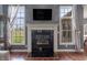 Cozy fireplace surrounded by windows, providing natural light and views of the outdoors at 6472 Independence Ct, Pendleton, IN 46064