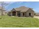 Attractive single-story brick home with lush lawn and covered entryway with decorative wreath on the door at 6472 Independence Ct, Pendleton, IN 46064