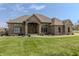 Charming single-story brick home with manicured lawn, mature landscaping, and covered front entryway at 6472 Independence Ct, Pendleton, IN 46064