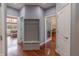 Hallway with hardwood floors, gray hall tree with bench, and neutral paint colors at 6472 Independence Ct, Pendleton, IN 46064