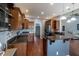Spacious kitchen featuring wood cabinets, granite counters, stainless appliances, and an eat-in bar at 6472 Independence Ct, Pendleton, IN 46064