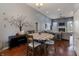 Open-concept living room with a dining area, fireplace, hardwood floors, and high ceilings at 6472 Independence Ct, Pendleton, IN 46064