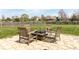Outdoor seating area with stone patio, surrounded by a green lawn and mature trees at 6472 Independence Ct, Pendleton, IN 46064