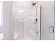 Bright bathroom shower features glass doors, built-in shelving, and a handheld shower head at 6472 Independence Ct, Pendleton, IN 46064