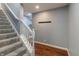 Carpeted stairway with white banister, hardwood landing, and neutral paint at 6472 Independence Ct, Pendleton, IN 46064