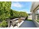 A quaint back deck featuring mature evergreens, and outdoor seating area, and a tranquil view at 7332 Quartz Rock Rd, Indianapolis, IN 46236