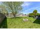 This well maintained backyard features a stone fire pit area and a lush green lawn at 7332 Quartz Rock Rd, Indianapolis, IN 46236