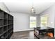 Bedroom with a modern light fixture, sleek desk, storage, and a large window at 7332 Quartz Rock Rd, Indianapolis, IN 46236