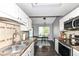 Modern kitchen view into dining area with view of stainless steel sink and stove top at 7332 Quartz Rock Rd, Indianapolis, IN 46236