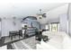 Spacious living room with dark floors, view into kitchen, dining, and front door at 7332 Quartz Rock Rd, Indianapolis, IN 46236