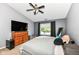Main bedroom featuring ceiling fan, dark walls, neutral paint, and wood furniture at 7332 Quartz Rock Rd, Indianapolis, IN 46236