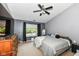 Main bedroom with gray walls, dark curtains, and a ceiling fan at 7332 Quartz Rock Rd, Indianapolis, IN 46236