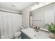 Bathroom featuring a blue vanity, shower with curtain, and decorative mirror at 7656 Madden Ln, Fishers, IN 46038