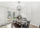 Bright dining area with modern light fixture, seamlessly connected to the deck through double doors at 7656 Madden Ln, Fishers, IN 46038