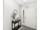 A neat entryway features tile floors and a decoratively furnished table, creating a welcoming first impression at 7656 Madden Ln, Fishers, IN 46038