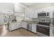 Modern kitchen boasting white cabinetry, stainless steel appliances, and granite countertops, designed for functionality and style at 7656 Madden Ln, Fishers, IN 46038