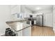 Bright kitchen with granite countertops, stainless steel appliances, and bar seating at 7656 Madden Ln, Fishers, IN 46038