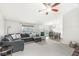 Bright living room with plush gray sectional and seamless flow into the dining area, great for entertaining at 7656 Madden Ln, Fishers, IN 46038