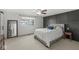 Bedroom featuring a statement wall, ceiling fan, and plush carpeting at 7656 Madden Ln, Fishers, IN 46038