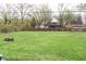 Spacious backyard features a wooden fence, grassy lawn and a place for a fire at 8017 Chiltern Dr, Indianapolis, IN 46268