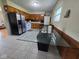 Eat-in kitchen includes tile flooring, wood cabinets, and stainless steel refrigerator at 8017 Chiltern Dr, Indianapolis, IN 46268
