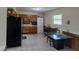 Eat-in kitchen features tile flooring, wood cabinets, and a glass top table and seating at 8017 Chiltern Dr, Indianapolis, IN 46268