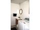Convenient laundry room and half-bath with a sink, mirror, and a washing machine at 8017 Chiltern Dr, Indianapolis, IN 46268