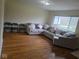 Bright living room features hardwood floors and a comfortable sectional sofa with decorative pillows at 8017 Chiltern Dr, Indianapolis, IN 46268