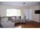 Inviting living room with hardwood floors, a comfortable sectional sofa, and abundant natural light at 8017 Chiltern Dr, Indianapolis, IN 46268