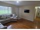 Cozy living room with hardwood floors and a comfortable gray sectional sofa near the door at 8017 Chiltern Dr, Indianapolis, IN 46268