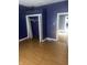Bedroom featuring plank flooring, a closet, and open doorway at 818 W 27Th St, Indianapolis, IN 46208