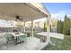 Large backyard featuring covered patio, seating, and plenty of greenery at 8327 Andrusia Ln, Indianapolis, IN 46237