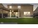 Spacious backyard patio with outdoor dining set, cafe lights, and room for entertaining at 8327 Andrusia Ln, Indianapolis, IN 46237