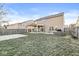 A home's backyard features a covered patio, grill, and partially dormant lawn at 8327 Andrusia Ln, Indianapolis, IN 46237