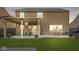 Spacious backyard featuring a covered patio with an outdoor dining area and a well-maintained lawn at 8327 Andrusia Ln, Indianapolis, IN 46237