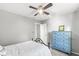 Bright bedroom featuring a ceiling fan and blue chest of drawers for storage at 8327 Andrusia Ln, Indianapolis, IN 46237