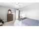 Cozy bedroom boasts neutral paint, a ceiling fan, dresser and a full sized bed at 8327 Andrusia Ln, Indianapolis, IN 46237
