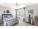 Comfortable bedroom features large windows with soft natural light, a ceiling fan and a full sized bed at 8327 Andrusia Ln, Indianapolis, IN 46237