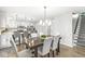 Dining area with a large table, seating for six, and views of the kitchen and staircase at 8327 Andrusia Ln, Indianapolis, IN 46237